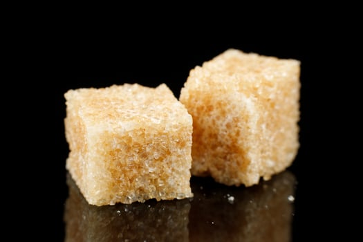Two pieces of brown sugar. Cane sugar. photo