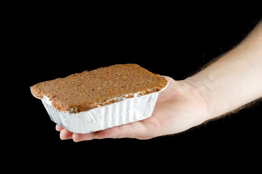 Liver pate in a container in hand photo