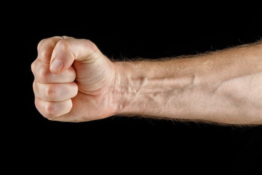 Close-up punch. Fist on black isolate. photo