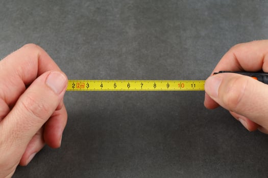 Self-retracting metal tape measure in hands. measuring tools photo