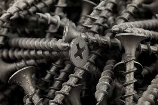 Screws black background. Close-up of metal screws photo