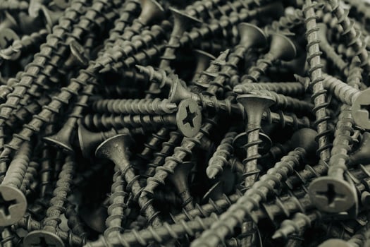 Screws black background. Close-up of metal screws photo