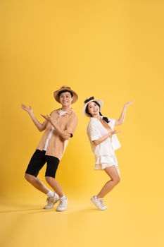 Portrait image of couple posing on yellow background, summer, travel photo