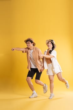 Portrait image of couple posing on yellow background, summer, travel photo