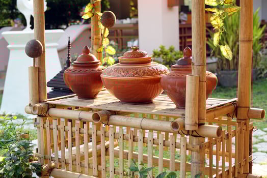 A bamboo drinking water booth for holding a set of clay pots filled with water and a hanging dipper from coconut shells represents the Thai water drinking culture in ancient times. photo