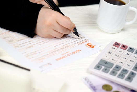 KYIV, UKRAINE - OCTOBER 31, 2023 Accountant fill italian tax form Modello 730 individual income tax return in end of tax period. Taxation and paperwork routine photo