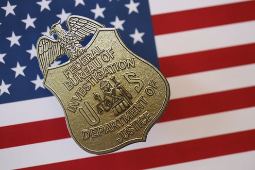 KYIV, UKRAINE - MARCH 9, 2024 US FBI Federal Bureau of Investigation badge on United States of America flag photo
