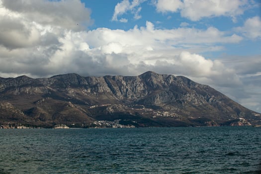 Spring in the mountains, beautiful mountain landscape. View of the mountain range and green trees. Summer, autumn and winter. Budva, Montenegro. Europe. Background. For text. Banner. Postcard. photo