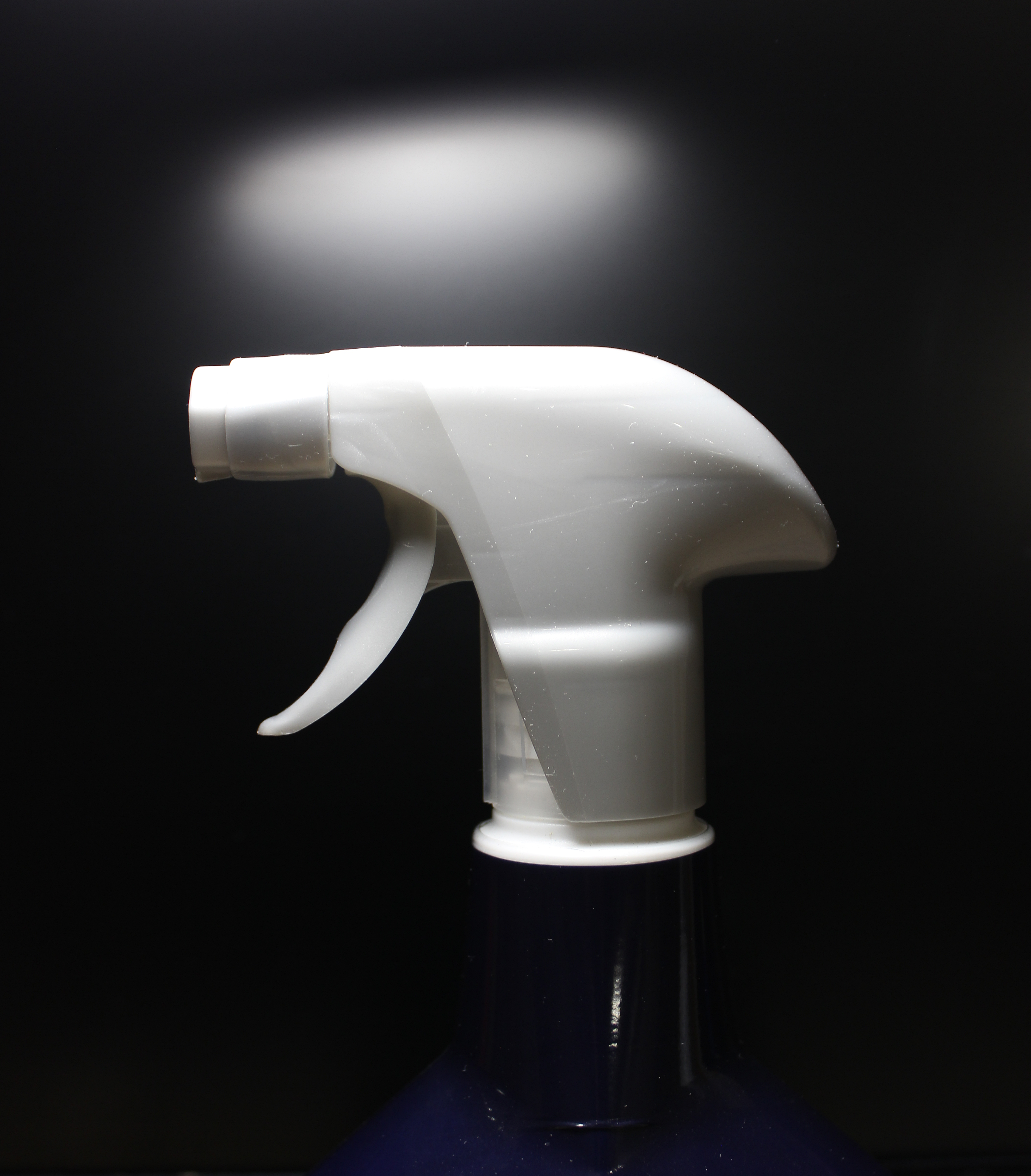 Plastic Bottle Of Liquid Cleaner With Sprayer Over Black Closeup Stock Photo