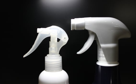 Top part of cleaning sprayers in the same direction on black background photo