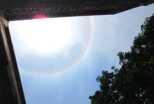 A 360-degree rainbow formed around the sun during midday as seen from ground photo