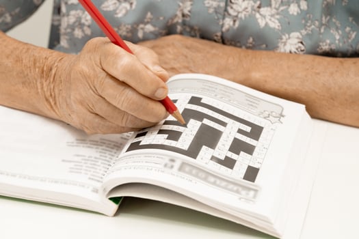 Alzheimer disease AD, Asian elderly woman playing sudoku puzzle game to practice for dementia prevention. photo