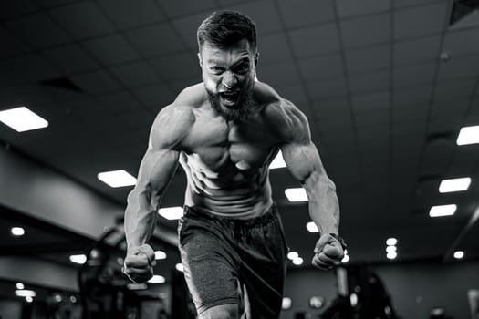 Bodybuilder with strong muscles. Hard training in gym shirtless man. photo
