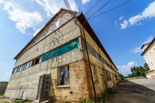 Outdoor abandoned factory house. Old exterior construction. photo