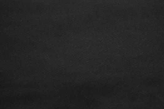 Dark Paper Texture with Spotlight on Dark Wall Background photo