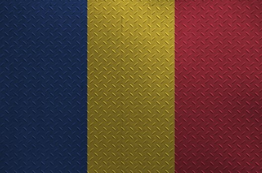 Romania flag depicted in paint colors on old brushed metal plate or wall closeup. Textured banner on rough background photo
