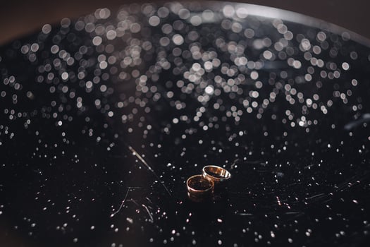 wedding rings on a dark background and drops of water photo