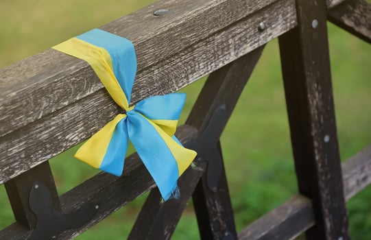 Ribbons in the colors of the national flag of Ukraine are tied to the handrail photo