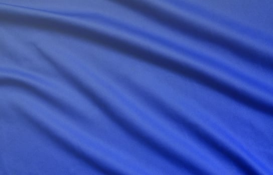 Detailed polyester blue fabric texture with many folds photo