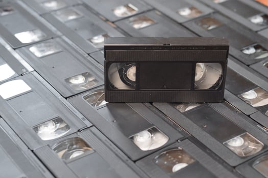 KYIV, UKRAINE - 4 MAY, 2023 tape on colored background, VHS, cassette. Messy stack of VHS tapes. Home System tape photo