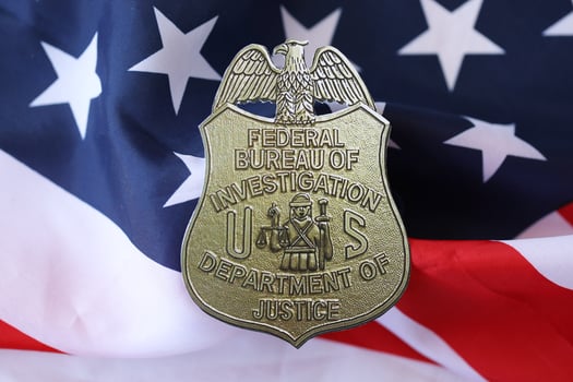 KYIV, UKRAINE - MARCH 9, 2024 US FBI Federal Bureau of Investigation badge on United States of America flag photo