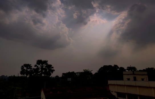 Sparkling beams of light extending from clouds during the rainy season in an Indian villgae photo