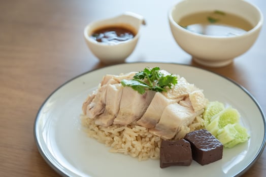 Closed up Singapore chicken rice with salted soya beans sauce and soup photo