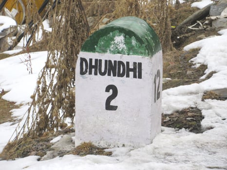 Dhundhi 2km ahead stone sign board Himachal Pradesh At a distance of 28 km from Manali Bus Stand and 15 km from Solang Valley photo