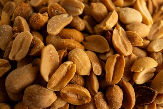 Pile of freshly shelled peanuts, perfect for food blogs, nutrition articles, or snack product advertisements. photo