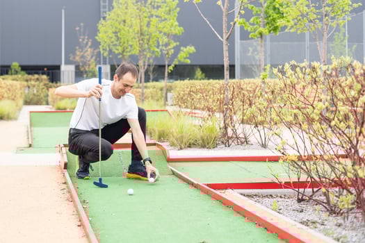 player looks at his hit on a mini golf course photo