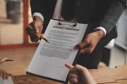 Real estate agent and Sales manager team analysis pricing of rental lease contract of sale purchase agreement, concerning mortgage loan offer for and house insurance. photo