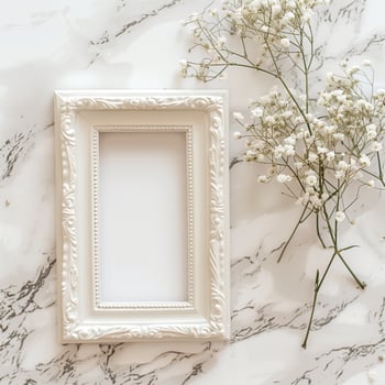 A white picture frame with an empty space inside, sitting on top of a marble surface. photo