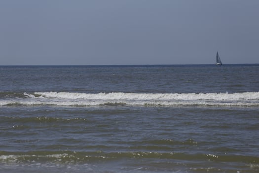 sailboat on the north sea, seen from the shore photo