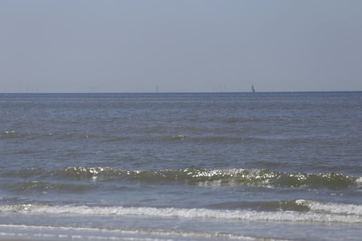 sailboat on the north sea, seen from the shore photo