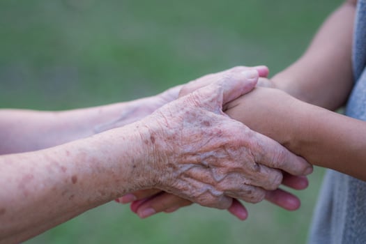 Hands of a grandmother holding the hands of a granddaughter. Encouragement concept photo