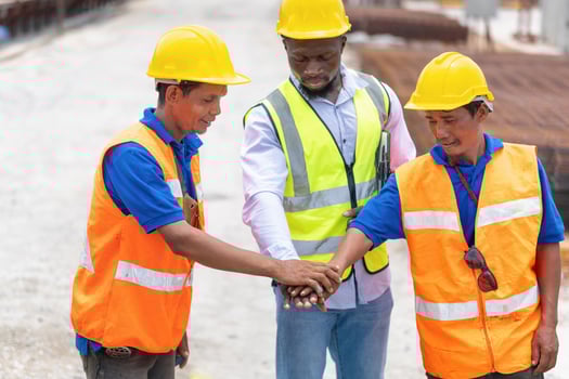 Success Teamwork Concepts, Engineer and workers team joining hands at a construction site photo