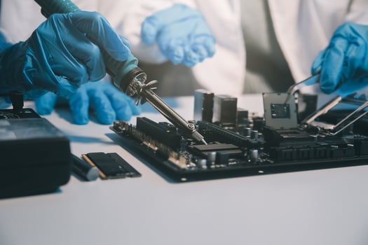 Close up of Technician measuring voltage electronic circuit board television, Service after sale fix electric equipment within insurance. photo