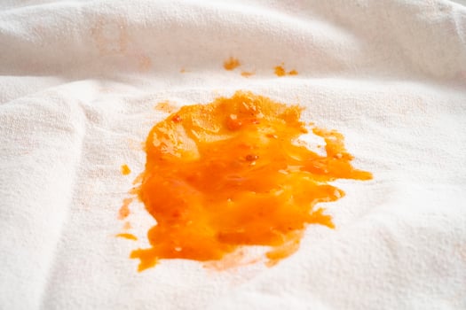 Dirty tomato sauce stain or ketchup on cloth to wash with washing powder, cleaning housework concept. photo