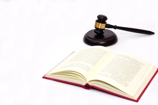 Selective focus, law book and judge gavel or hammer placed behind. Law, judiciary concept. photo