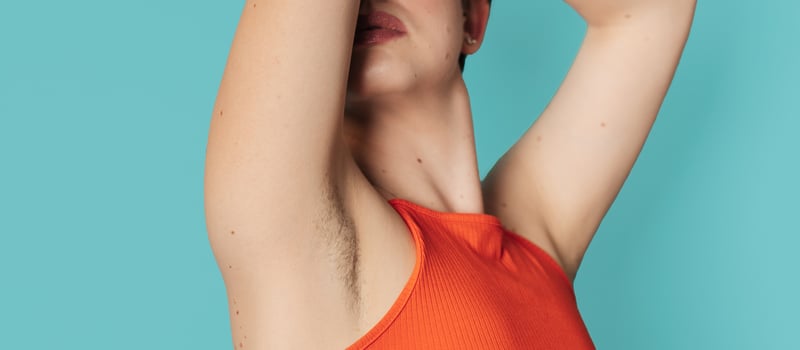 An unshaven young woman flaunting her unshaven armpits. Panoramic banner. Body positive young woman who decided not to shave. photo