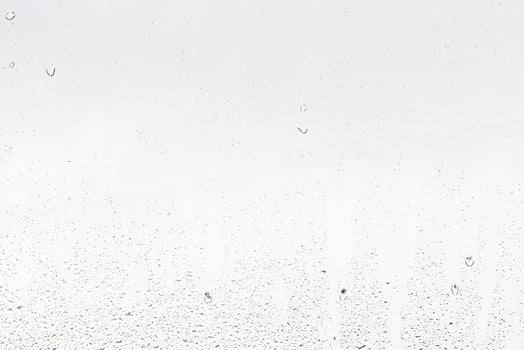 Rain drops on window glasses surface with gray sky background . Natural backdrop of raindrops. Abstract overlay for design. The concept of rainy weather. photo