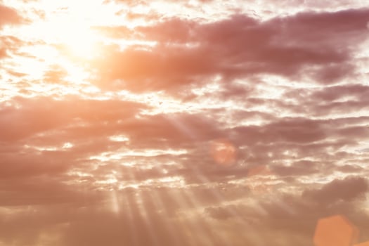 Sun rays breaking through cumulus clouds. The concept of divine light, a glimmer of hope or overcoming difficulties. Spiritual religious background. photo