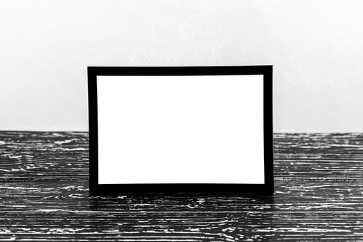 Wooden floor over concrete or decorative plaster wall and black photo frame with copy space for a text background. Mock up.