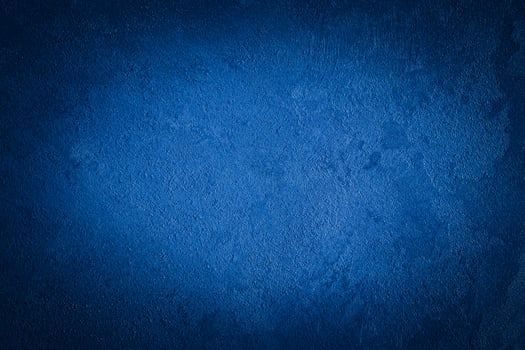 Blue decorative plaster texture with vignette. Abstract grunge background with copy space. photo