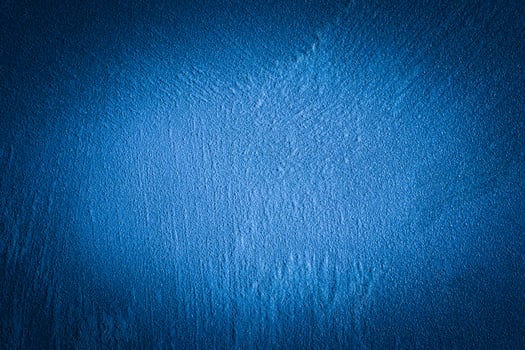 Blue decorative plaster texture with vignette. Abstract grunge background with copy space. photo