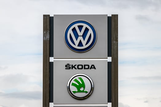 Russia, Kaluga - SEPTEMBER 29, 2020 Metallic Volkswagen and Skoda logos on a stand of a dealership. photo