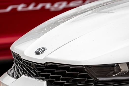 Russia, Kaluga - SEPTEMBER 29, 2020 Chromed Kia Motors logo on a white hood of a new car. photo