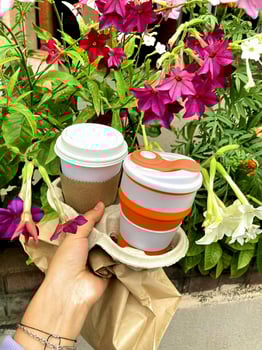 Female hands hold reusable coffee mug. Sustainable lifestyle. Eco friendly concept photo