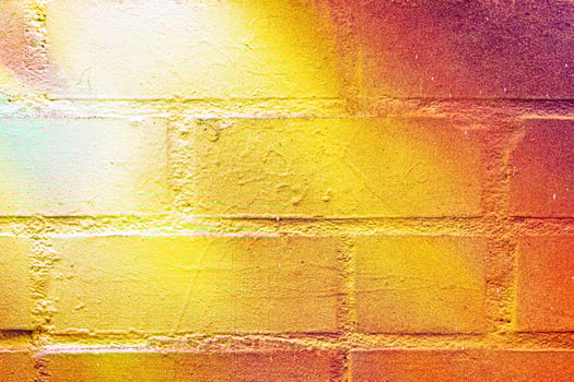 A fragment of colorful graffiti painted on a wall. Abstract urban background. photo