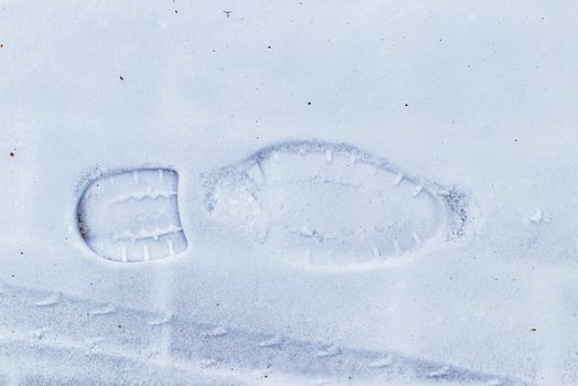 Boot track on thin first snow in winter. photo